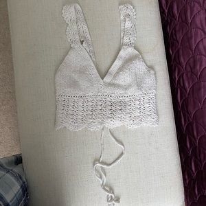 a white knitted/crotchet tank top